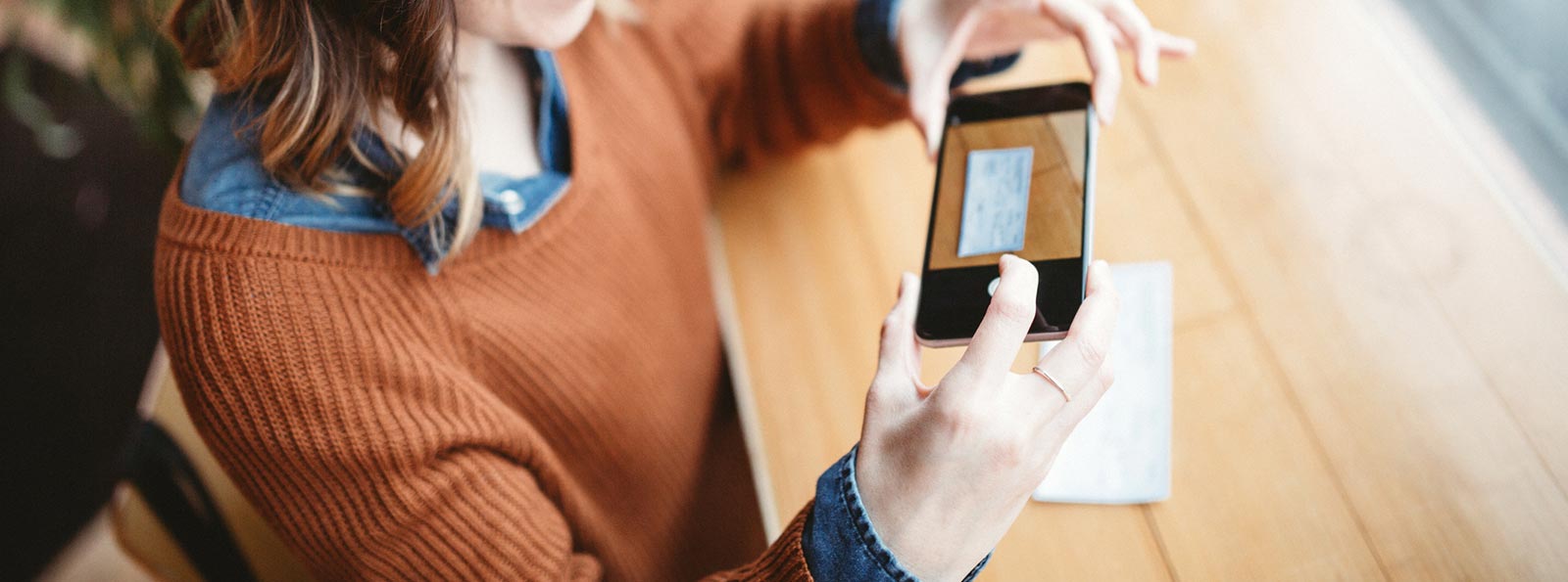 Lady using smartphone to make a mobile deposit